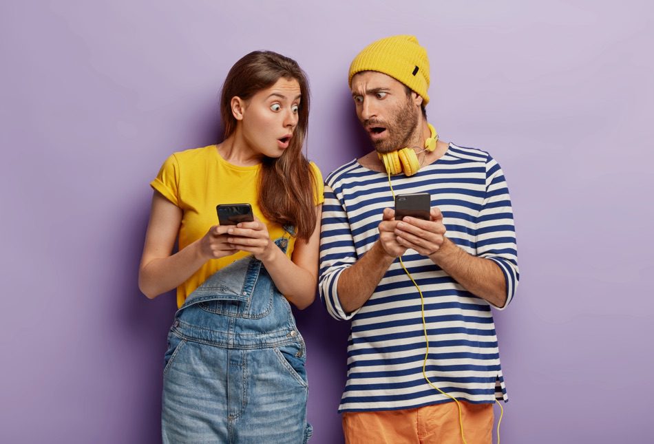 man and woman on cell phone