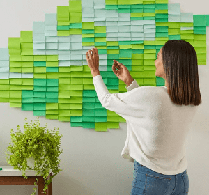 Woman putting sticky notes on a wall